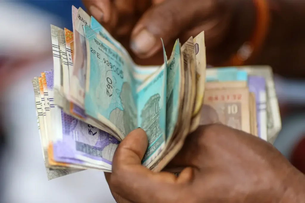 Stacks of Indian rupee notes symbolizing the wealth of India's super-rich and the challenges of tax transparency.