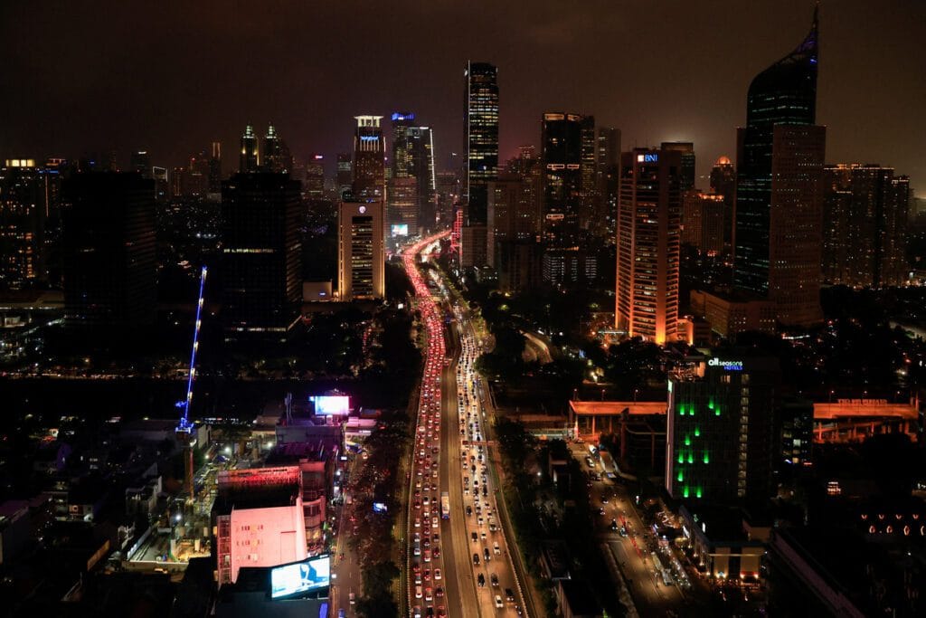 Jakarta skyline at sunset, representing Indonesia's evolving economic landscape and the government's new VAT policy on luxury goods.