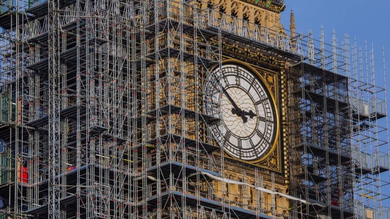 UK Parliament building with tax documents overlay, symbolizing corporate tax reform