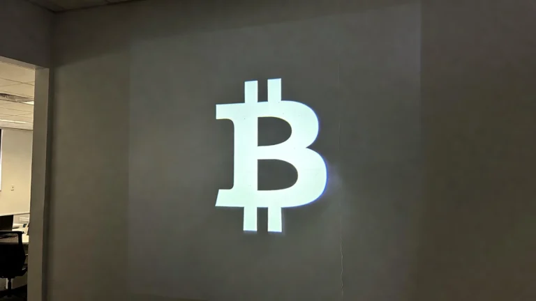 The 0% Revolution: Why Crypto Tax El Salvador Changes Everything Close-up of a digital Bitcoin symbol projected onto a modern office wall